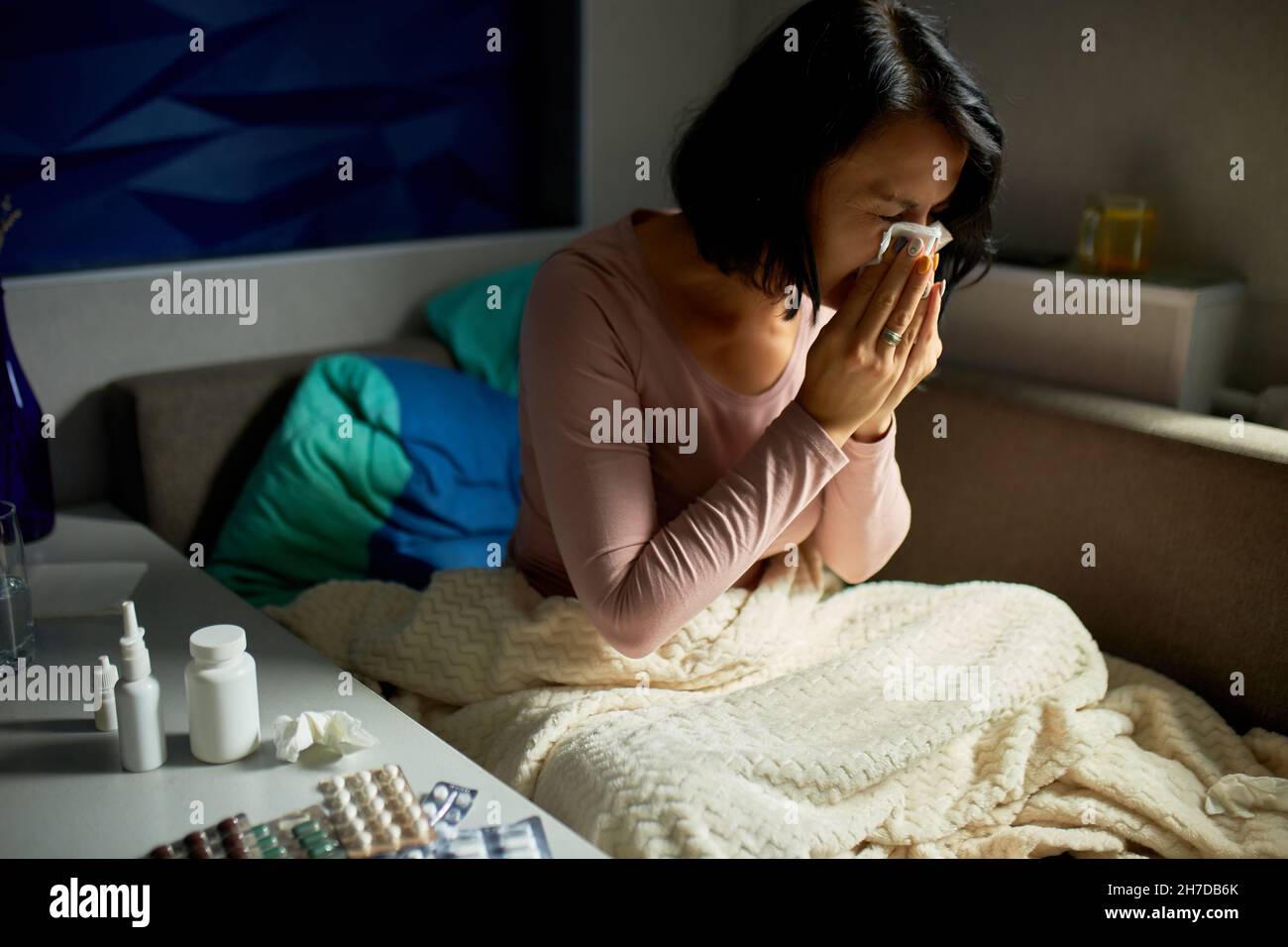 Ill woman with seasonal infections flu allergy and runny nose wiping