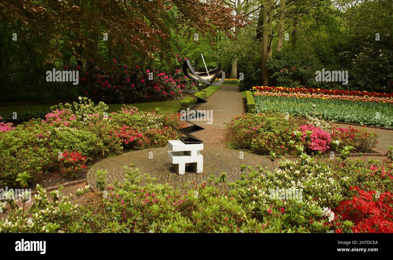 Beautiful view of colorful flowers and a sculpture in Keukenhof park ...