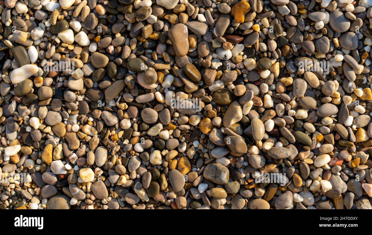 Natural background with small sea pebbles on the beach Stock Photo - Alamy