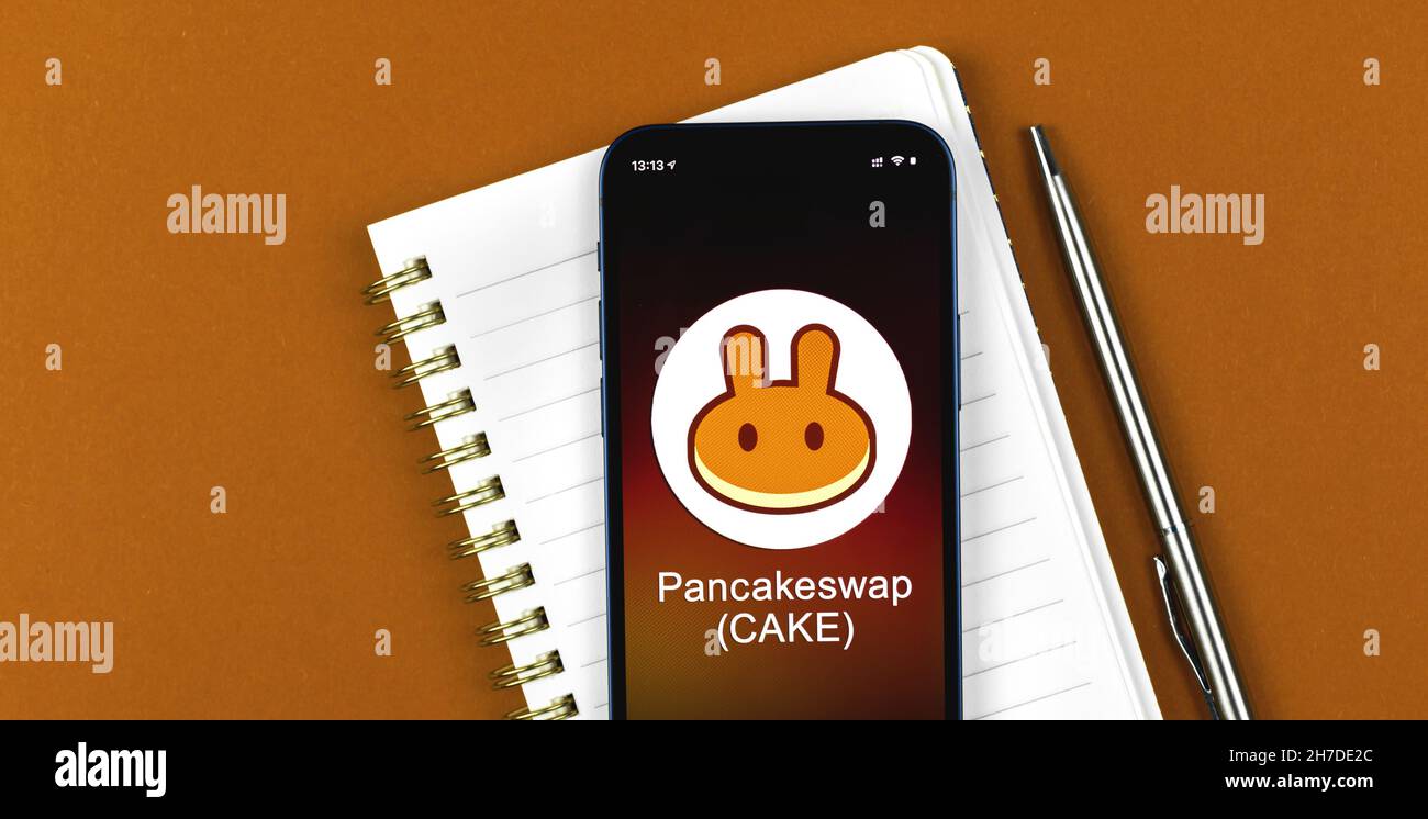 Pancakeswap symbol. Trade with cryptocurrency, digital and virtual money,  banking with mobile phone concept. Business workspace, banner, table top  vie Stock Photo - Alamy