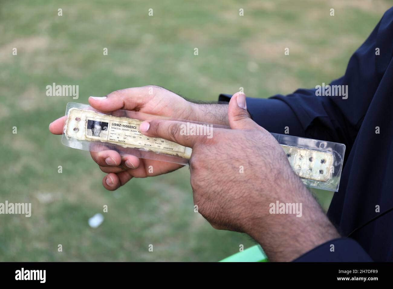 Baghdad. 22nd Nov, 2021. Alaah Karim Ahmed shows his prison identification bracelet in Duluiyah town of Salahuddin province, Iraq, Nov. 2, 2021. TO GO WITH: 'Feature: Former prisoner in Abu Ghraib reveals U.S. brutal crimes in Iraq' Credit: Xinhua/Alamy Live News Stock Photo