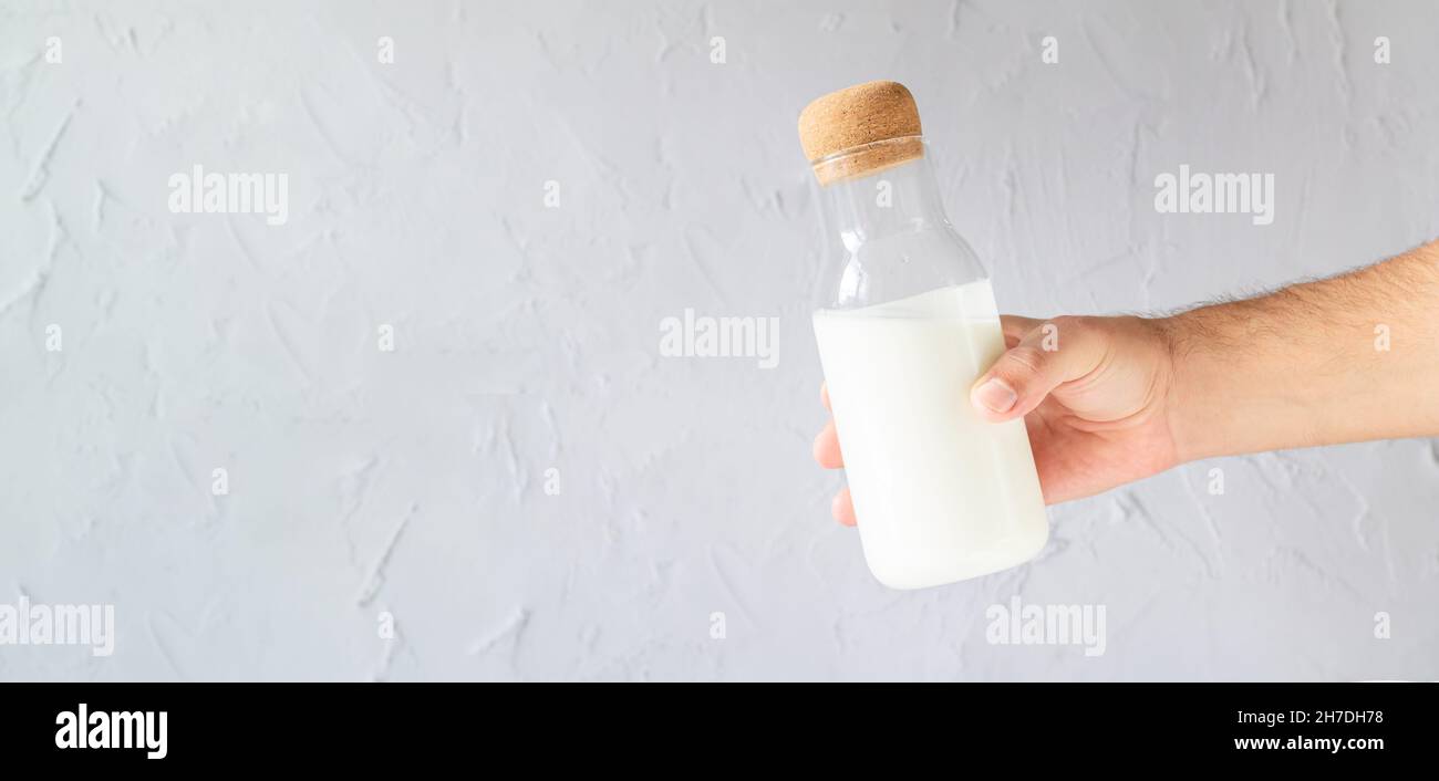 Man holding bottle of homemade yogurt, kefir, buttermilk or natural fermented milk Stock Photo