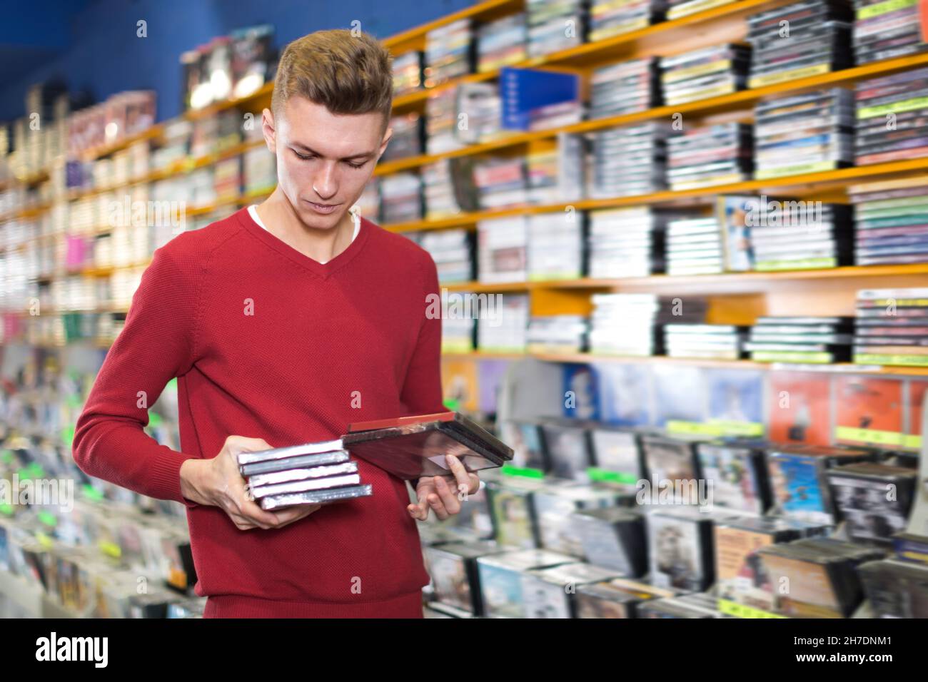 Glad man looking for interesting movies Stock Photo