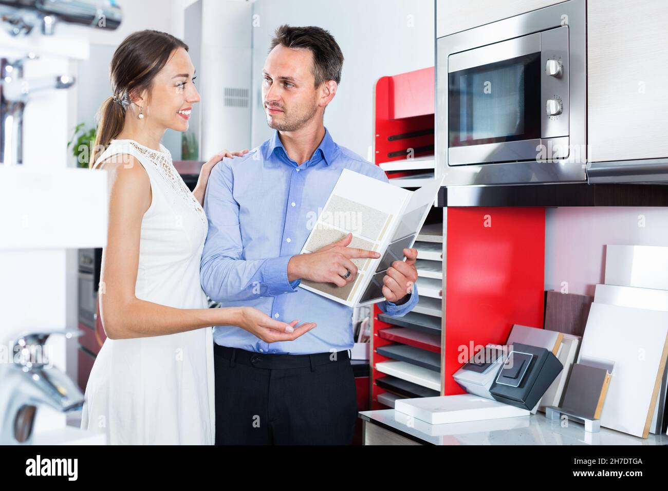 Family couple looking for new utility tabletop in furniture store Stock