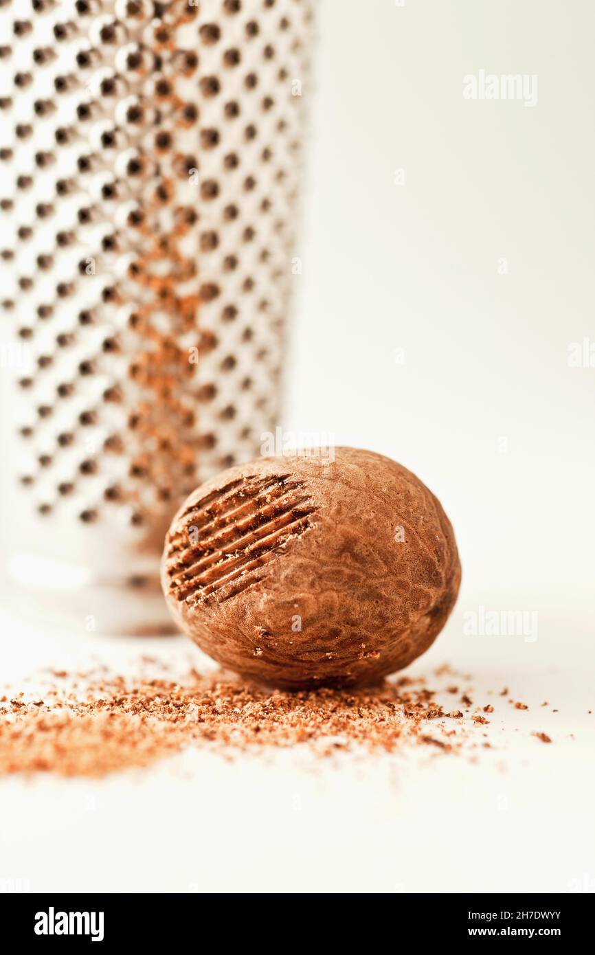 A whole nutmeg with a grater Stock Photo Alamy