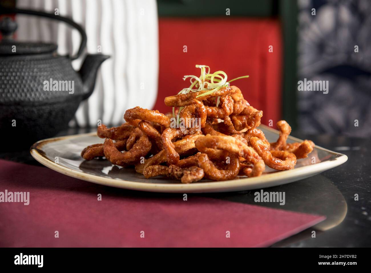 Filipino style deep fried crispy squid glazed with chilli honey and garlic Stock Photo