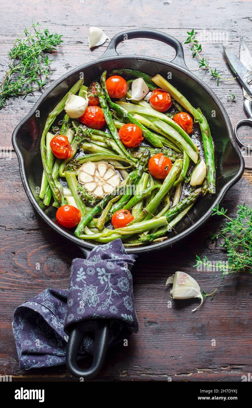 Fried asparagus with garlic and cherry tomatoes Stock Photo Alamy