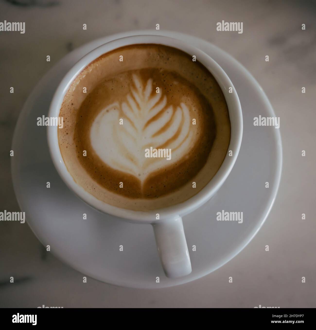 cup of cappuccino on a table with latte art Stock Photo
