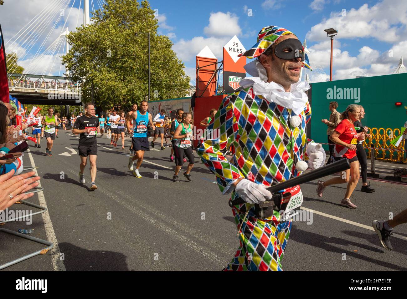 Man dressed as a joker running, Virgin Money London Marathon 2021 at the 25 mile point, Victoria Embankment. Stock Photo