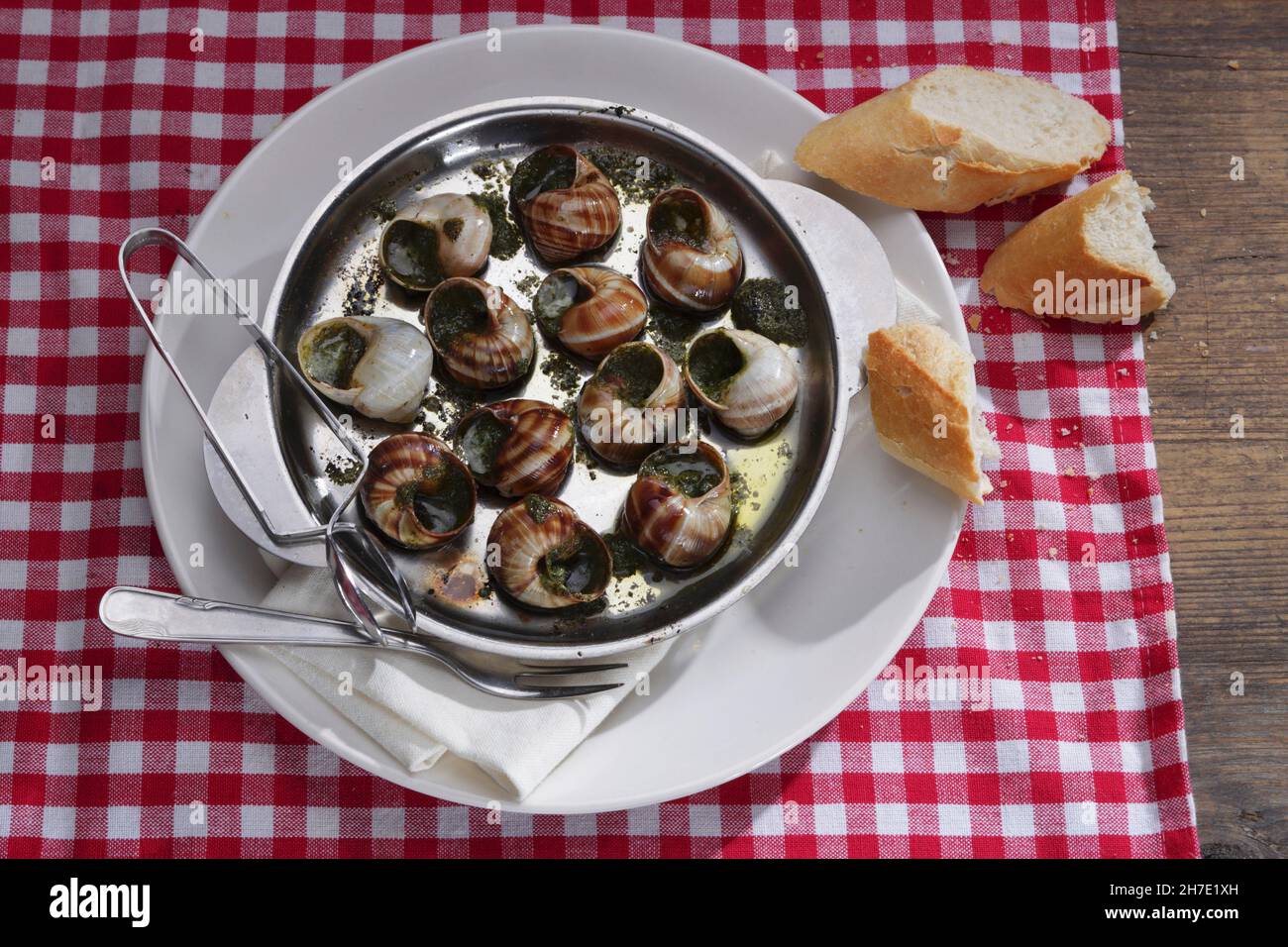 Vineyard snails with herb butter and baguette Stock Photo