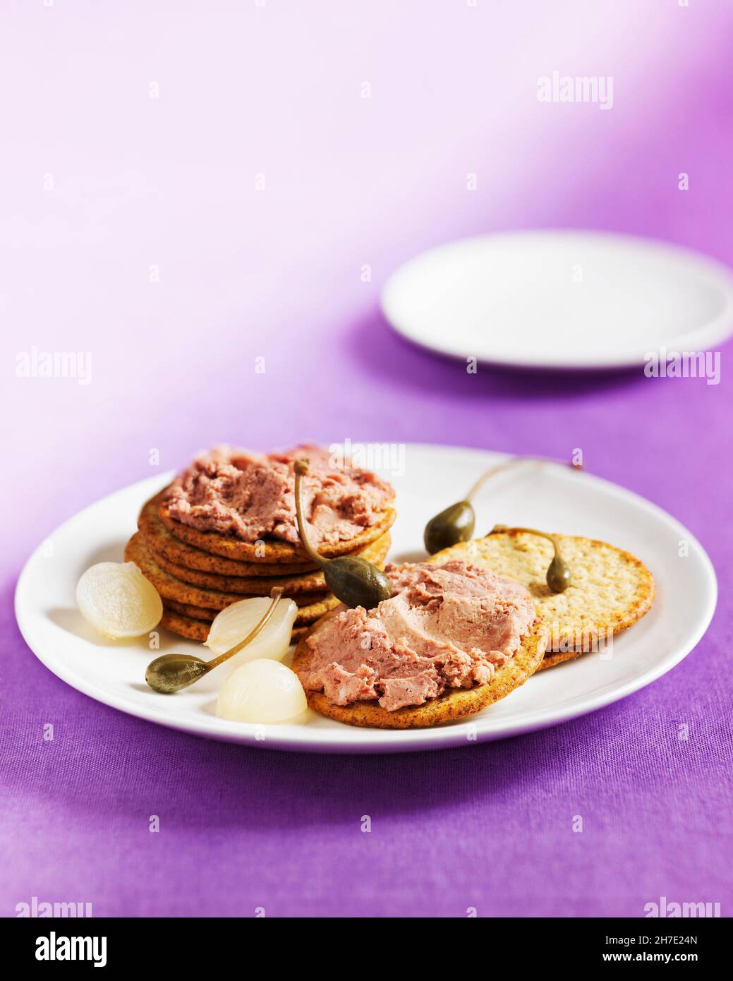 Biscuits with liver pâté, capers and pearl onions Stock Photo