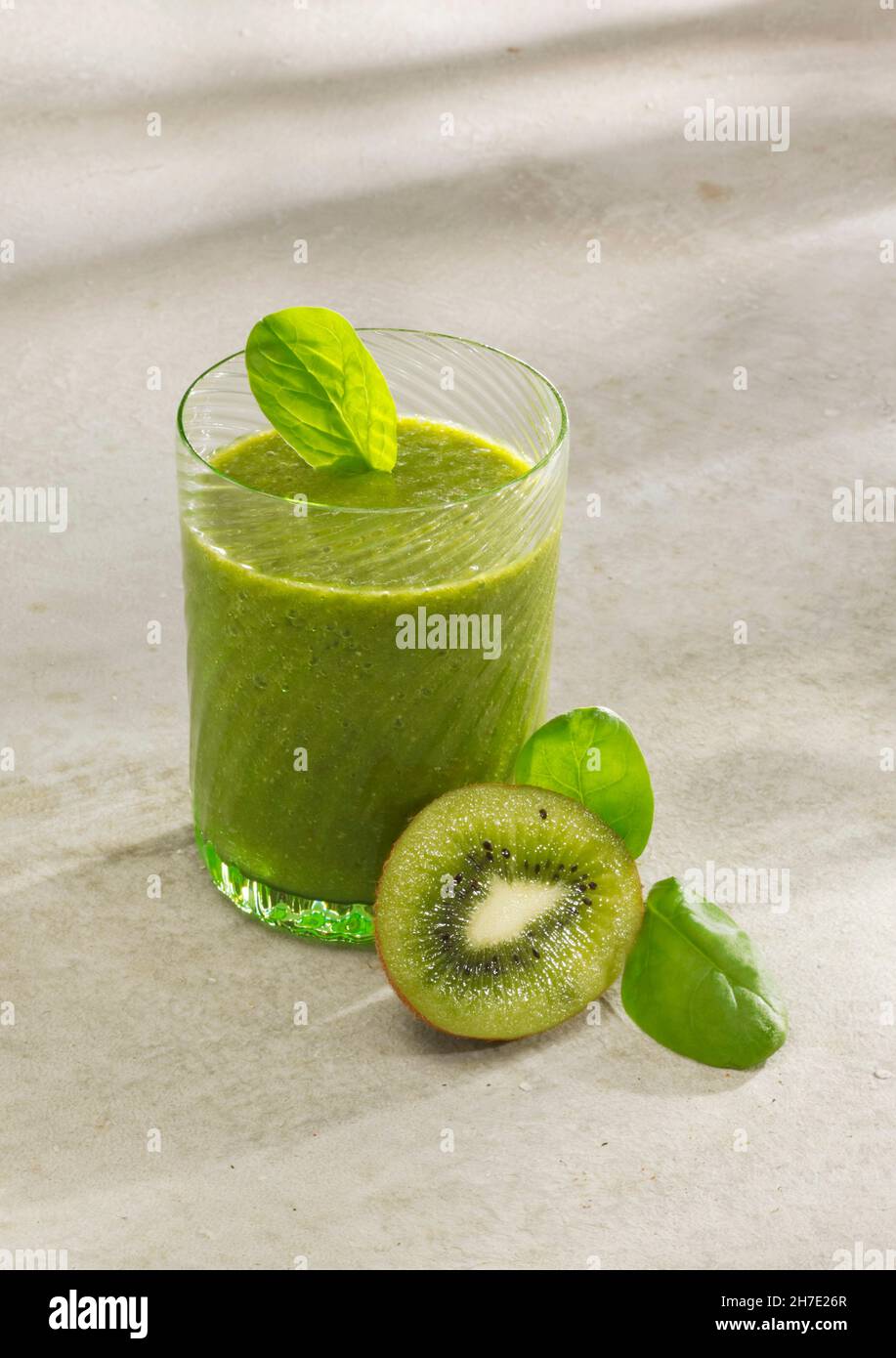 Spinach and kiwi smoothie with almond milk, chia seeds and wheat grass