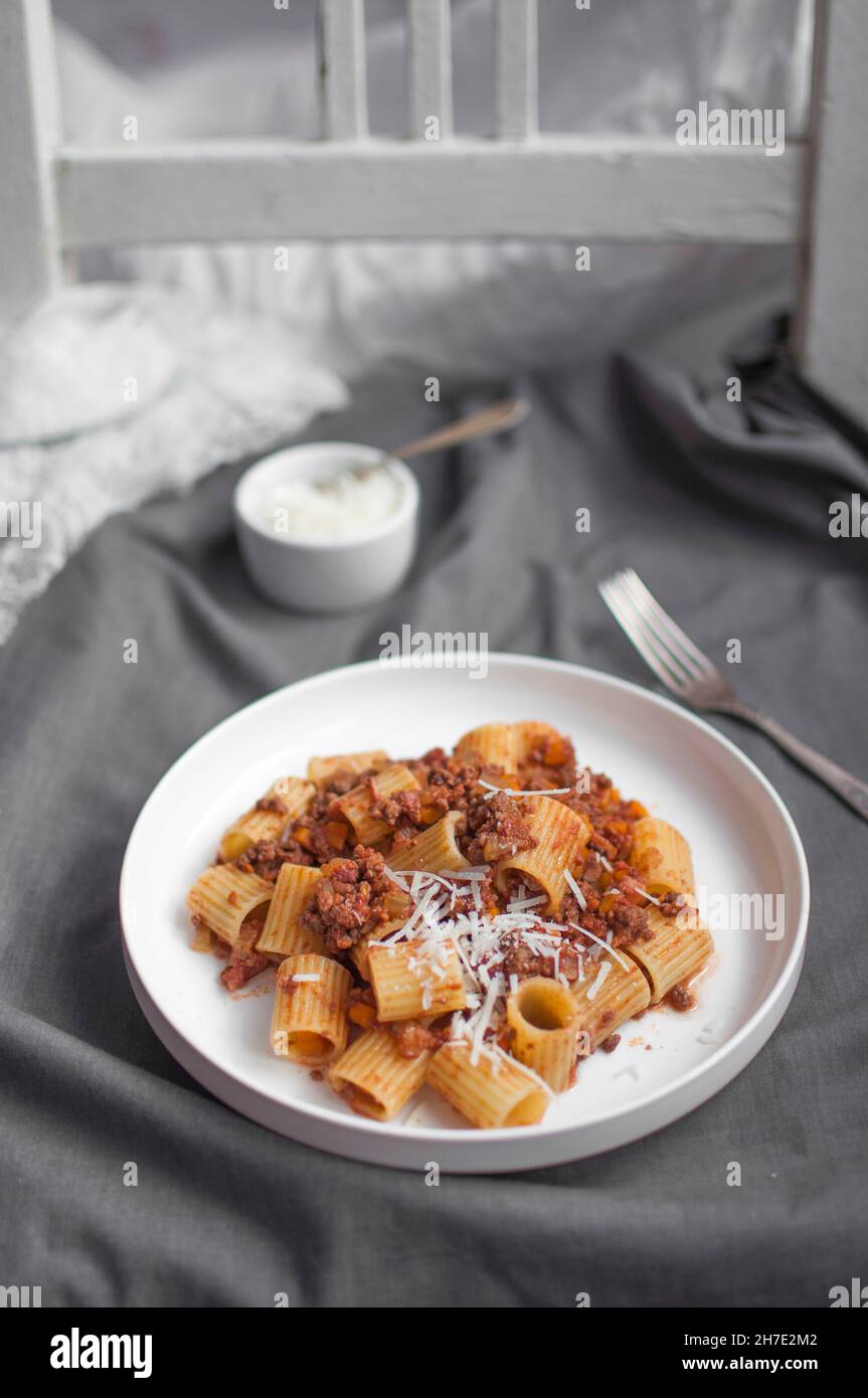 Mezze rigate with bolognese ragu and grated parmesan Stock Photo - Alamy