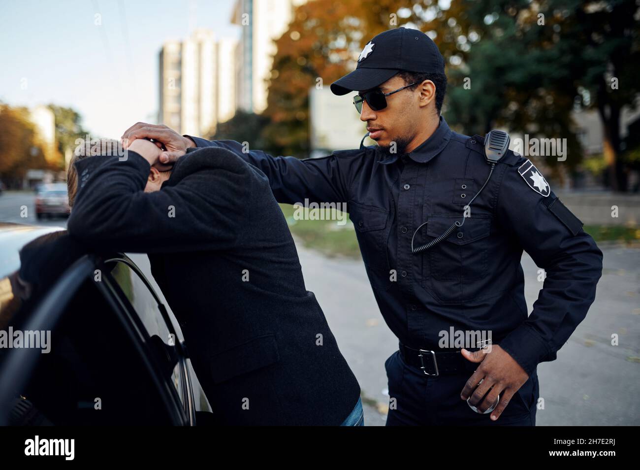 Police patrol arrests male driver near the car Stock Photo