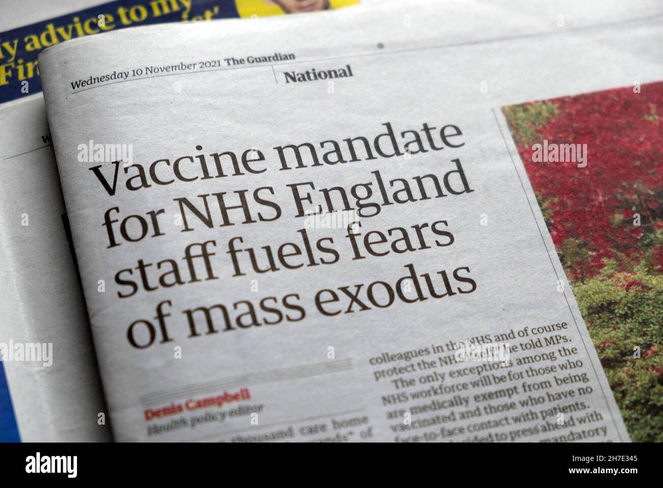 'Vaccine mandate for NHS England staff fuels fears of mass exodus' Guardian newspaper headline covid 19 article 10 November 2021 London UK Stock Photo