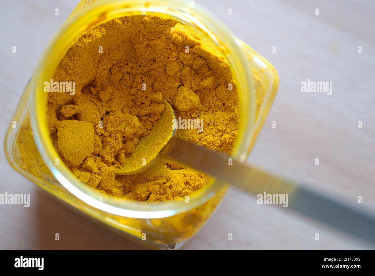 Turmeric powder in a jar with a spoon Stock Photo Alamy