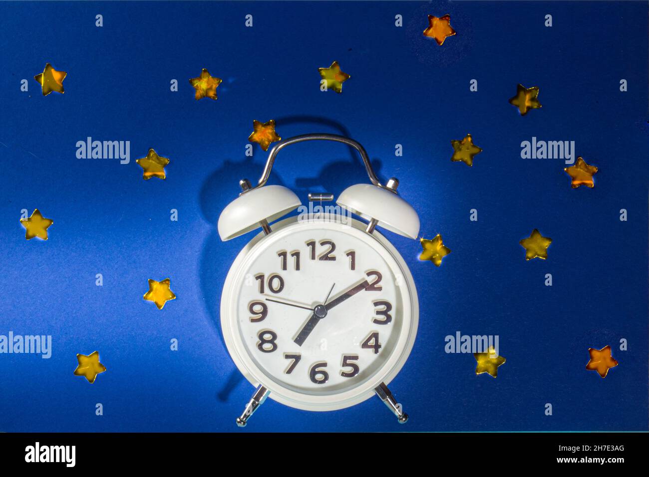 Circadian rhythms with white alarm clock, night and day backgrounds