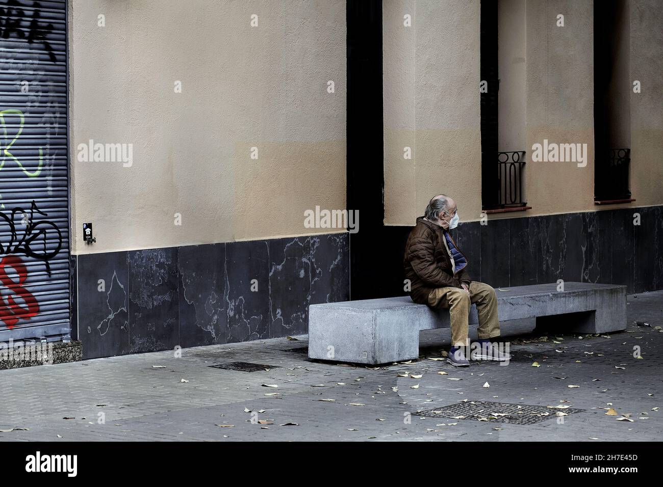 Old man sat on concrete bench, Barcelona, Spain. Stock Photo