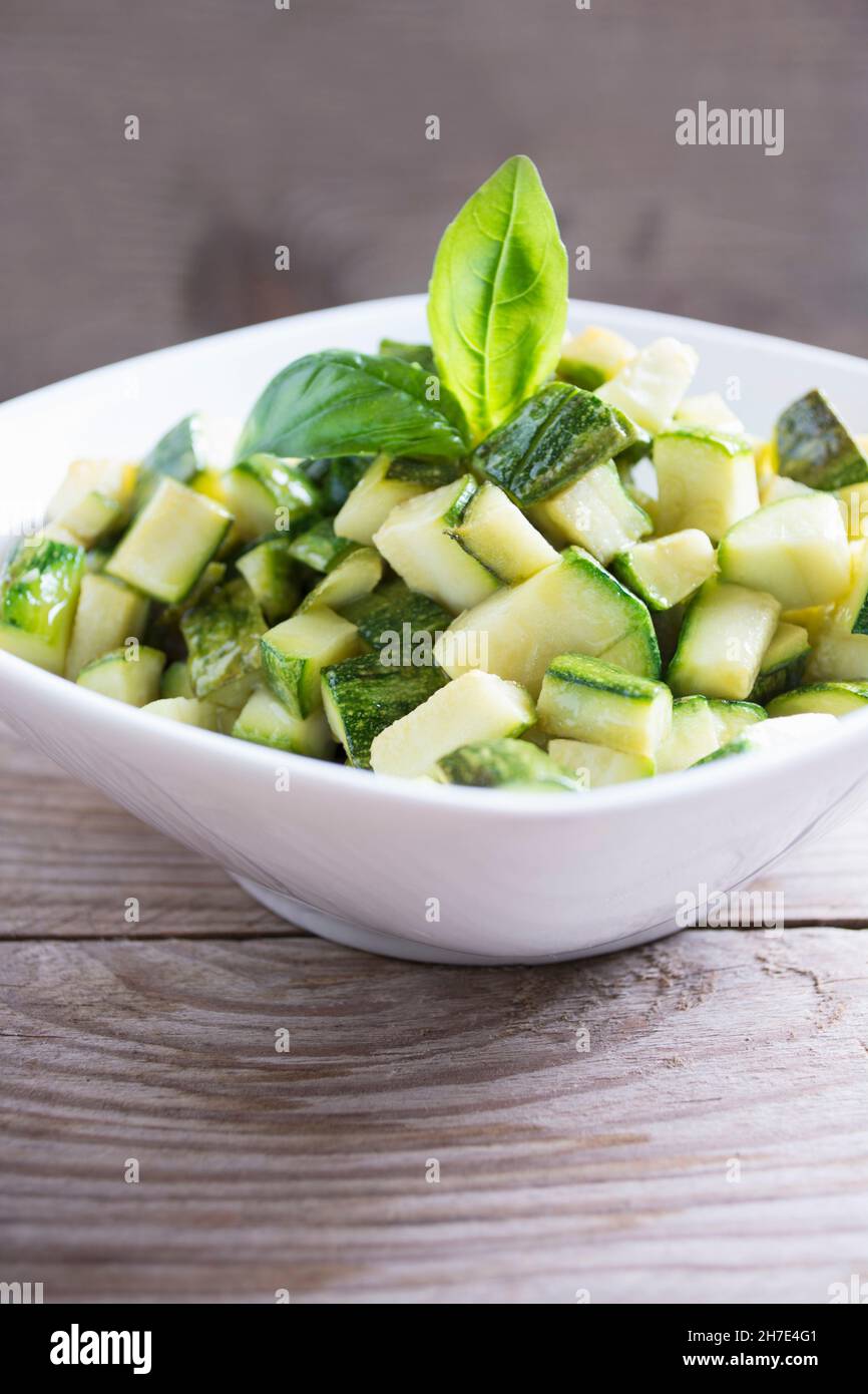 Diced zucchini in a bowl on a wood table Stock Photo Alamy