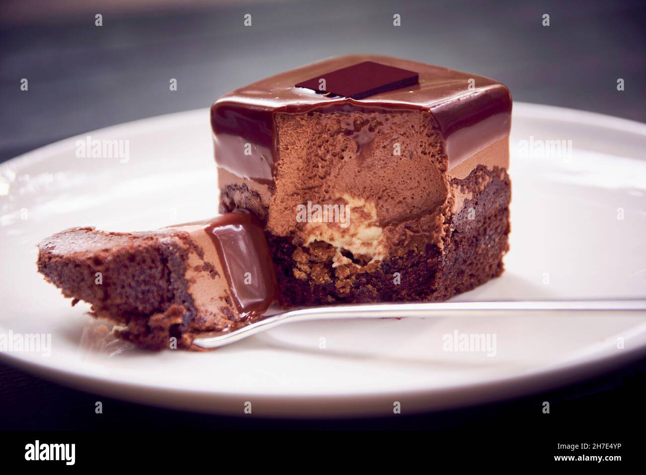 A chocolate petit four that has been bitten into Stock Photo