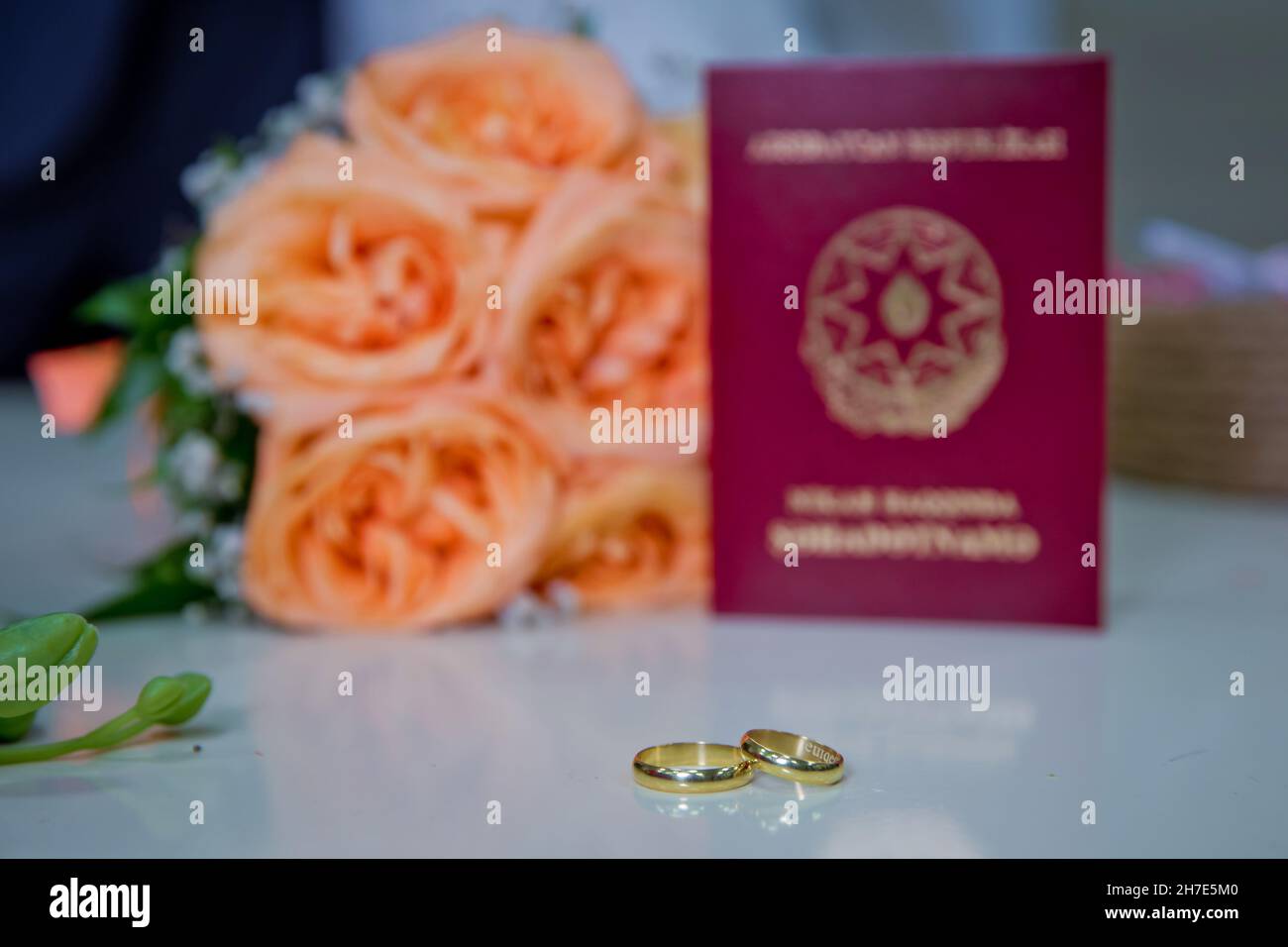 Azerbaijan Baku 7.07.2020 . Marriage Certificate of the Republic of  Azerbaijan .Yellow gold engagement rings against the background of a  bouquet of fl Stock Photo - Alamy