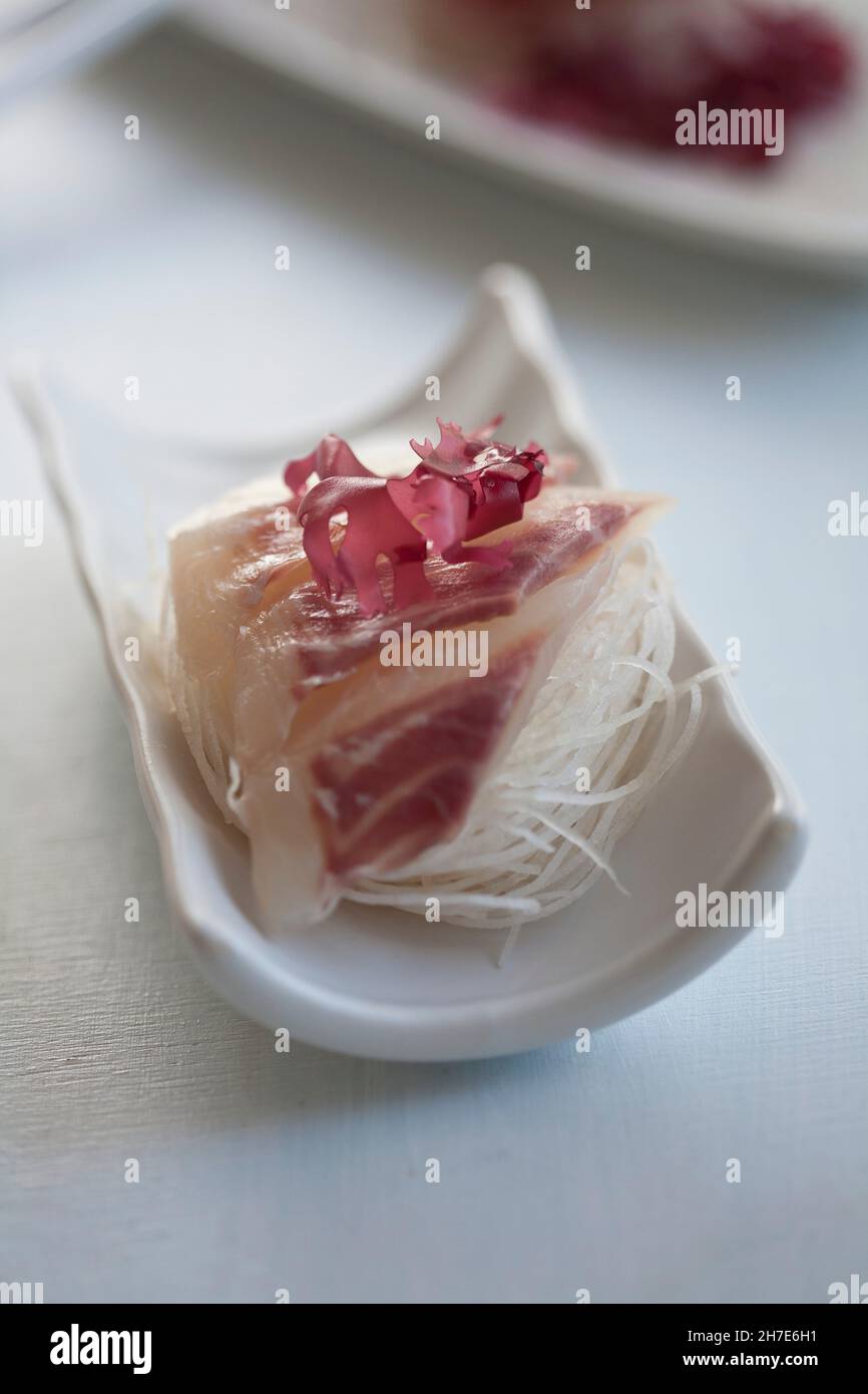 Bream sashimi on strips of radish Stock Photo