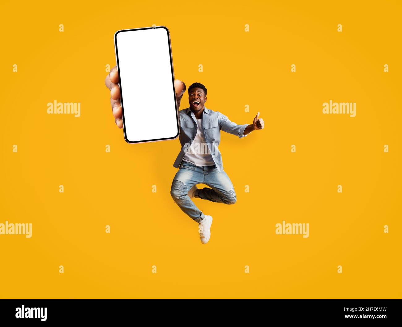 Man mobile phone jumping joy hi-res stock photography and images - Alamy