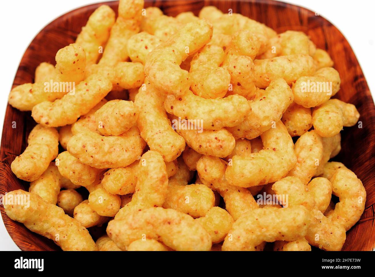 Puffed corn snacks with peanuts and cheese taste in a bowl Stock Photo