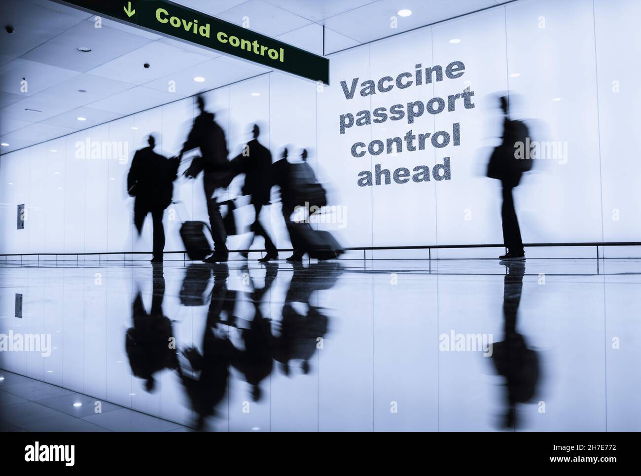 Covid vaccine airport concept image. Businessmen with luggage arriving at airport arrivals Covid control. Stock Photo