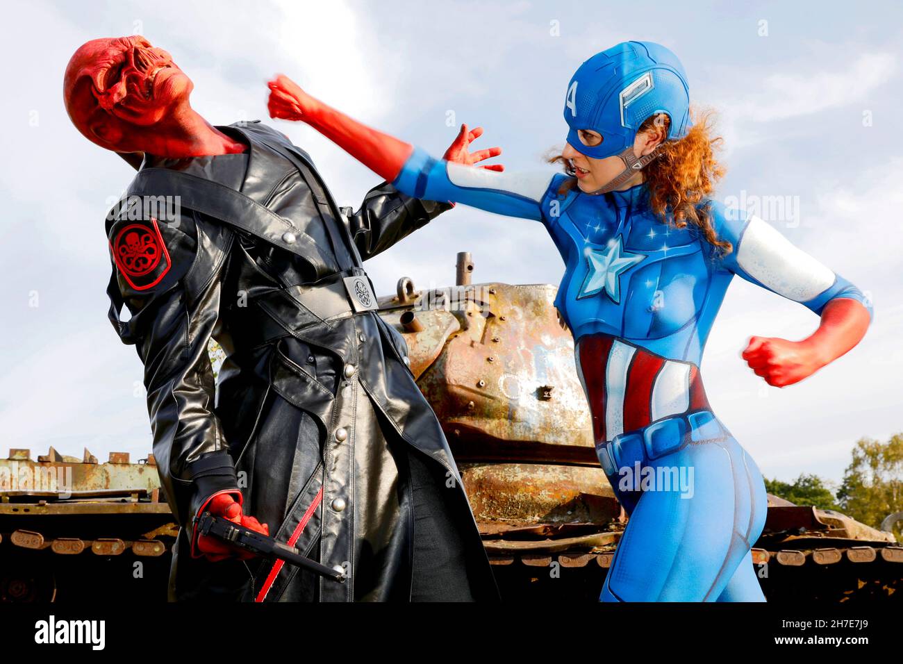 From the Colored Bodies Calendar 2022 - Geek Art-Bodypainting and Transformaking: Captain America vs. Red Skull photoshooting with Lena and Patrick on a military training area in Langenhagen. A project by the photographer Tschiponnique Skupin and the bodypainter Enrico Lein. Stock Photo