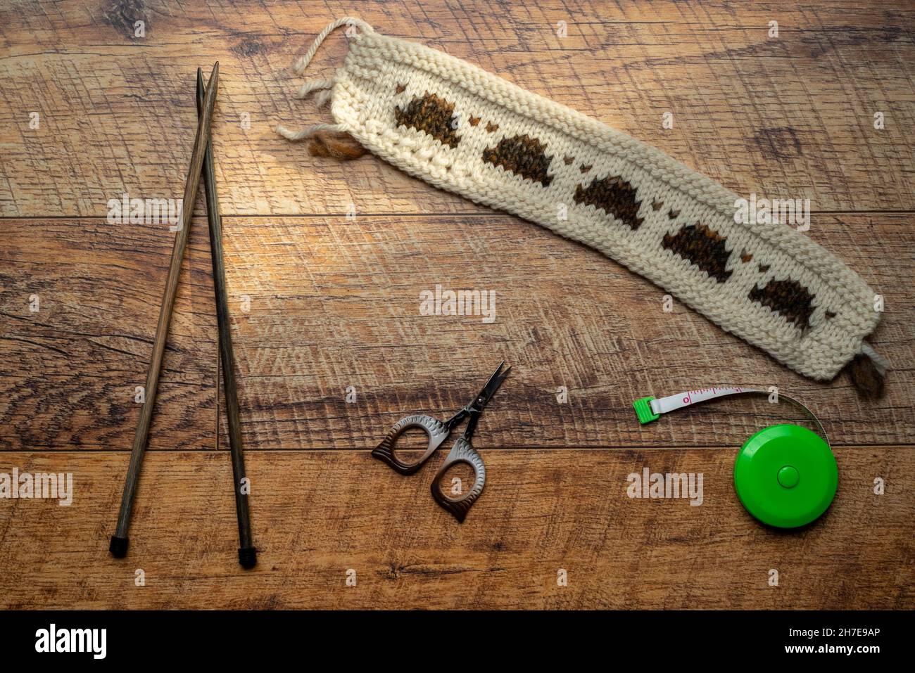 Long white and patterned knitted swatch testing with knitted piece Stock Photo