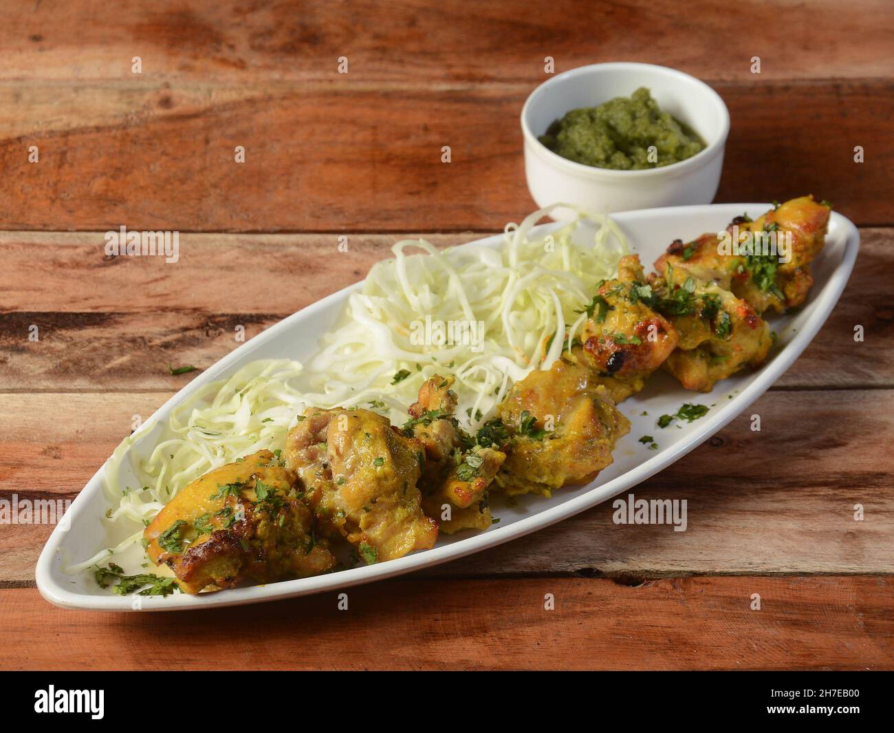 Murgh bangara kebab on wooden background. Dishes and appetizers of indian cuisine, selective focus Stock Photo