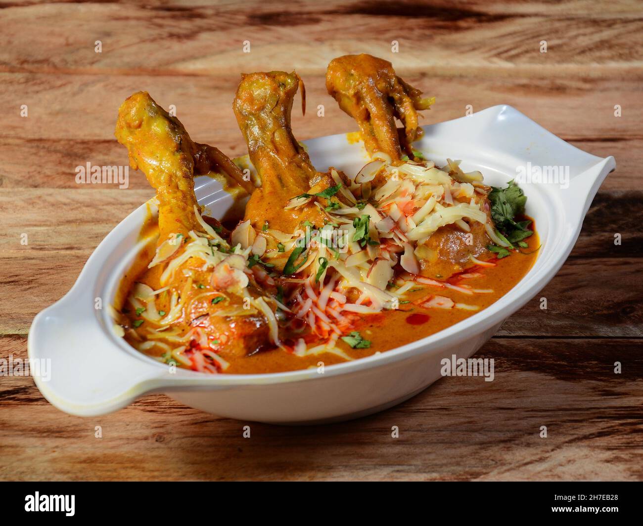 Nawabi murgh served on a rustic wooden background. Dishes and appetizers of indian cuisine, selective focus Stock Photo