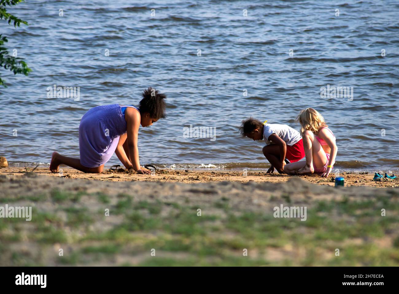 Three girls playing by the river In the park, Pennsylvania, USA Stock Photo