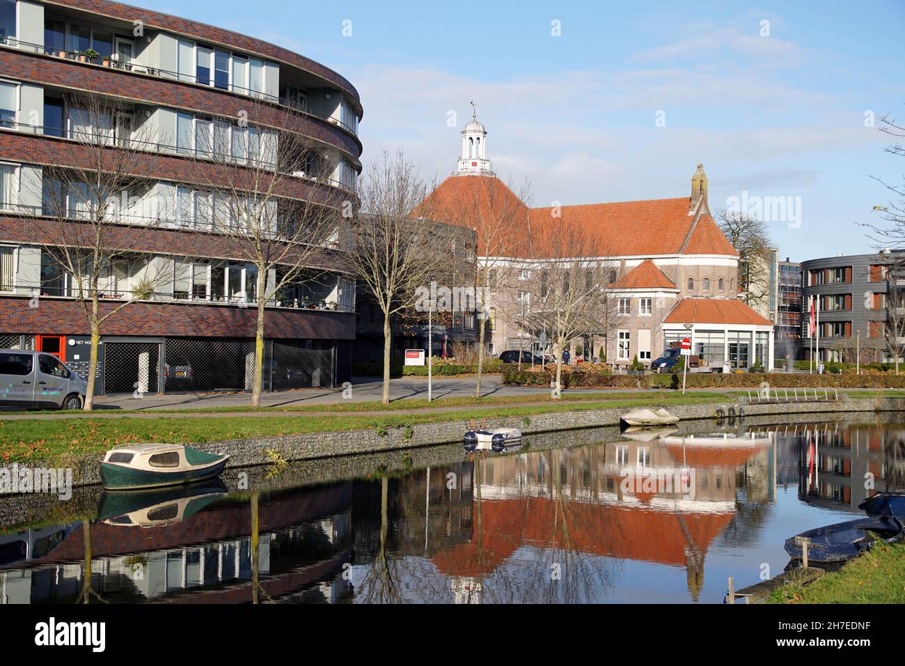 Dutch nursing home Westerhout, Alkmaar. The former Roman Catholic St. Elisabeth Hospital, Apartments. Reflected in the water of the canal. Autumn. Stock Photo