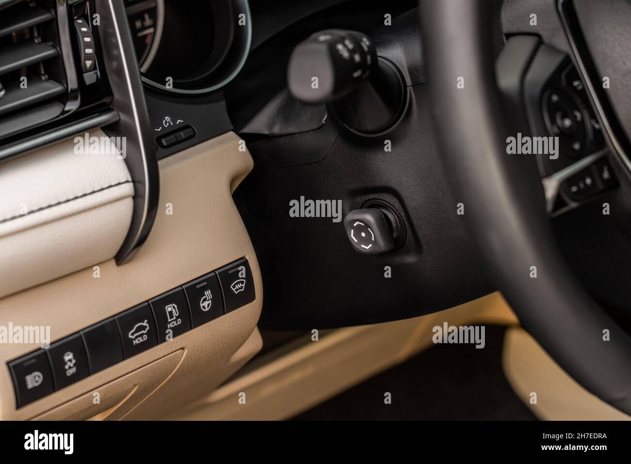 Adjustable steering wheel in modern car. Tilt and telescopic steering control lever. Steering