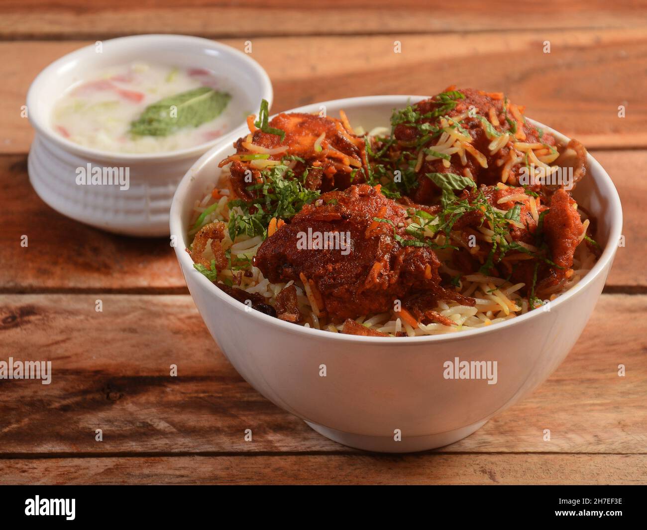 Boneless Chicken dum Biryani made of Basmati rice cooked with masala spices, served with Onion