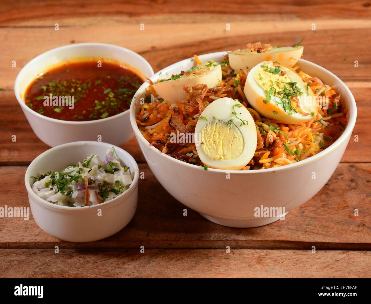 Dum Raita Traditional Hyderabadi Chicken dum Biryani made of Basmati rice cooked ...