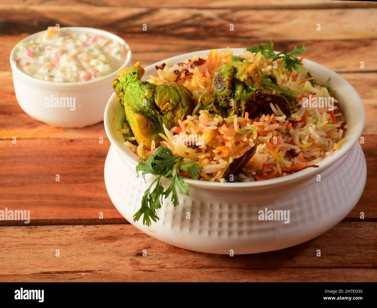 Dum Raita Traditional Hyderabadi Chicken dum Biryani made of Basmati rice cooked ...