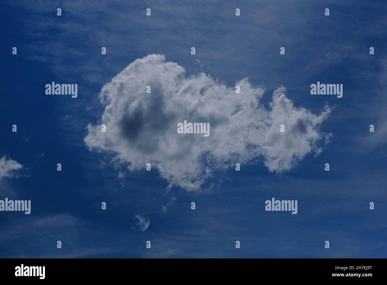 Low angle shot of a cloud in the dark blue sky Stock Photo - Alamy