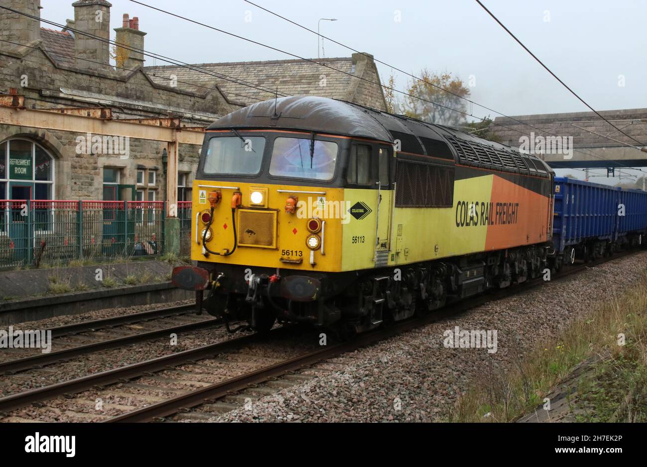 Class 56 diesel-electric locomotive number 56 113 passing through Carnforth on the West Coast Main Line with a fregiht train on 22nd November 2021. Stock Photo