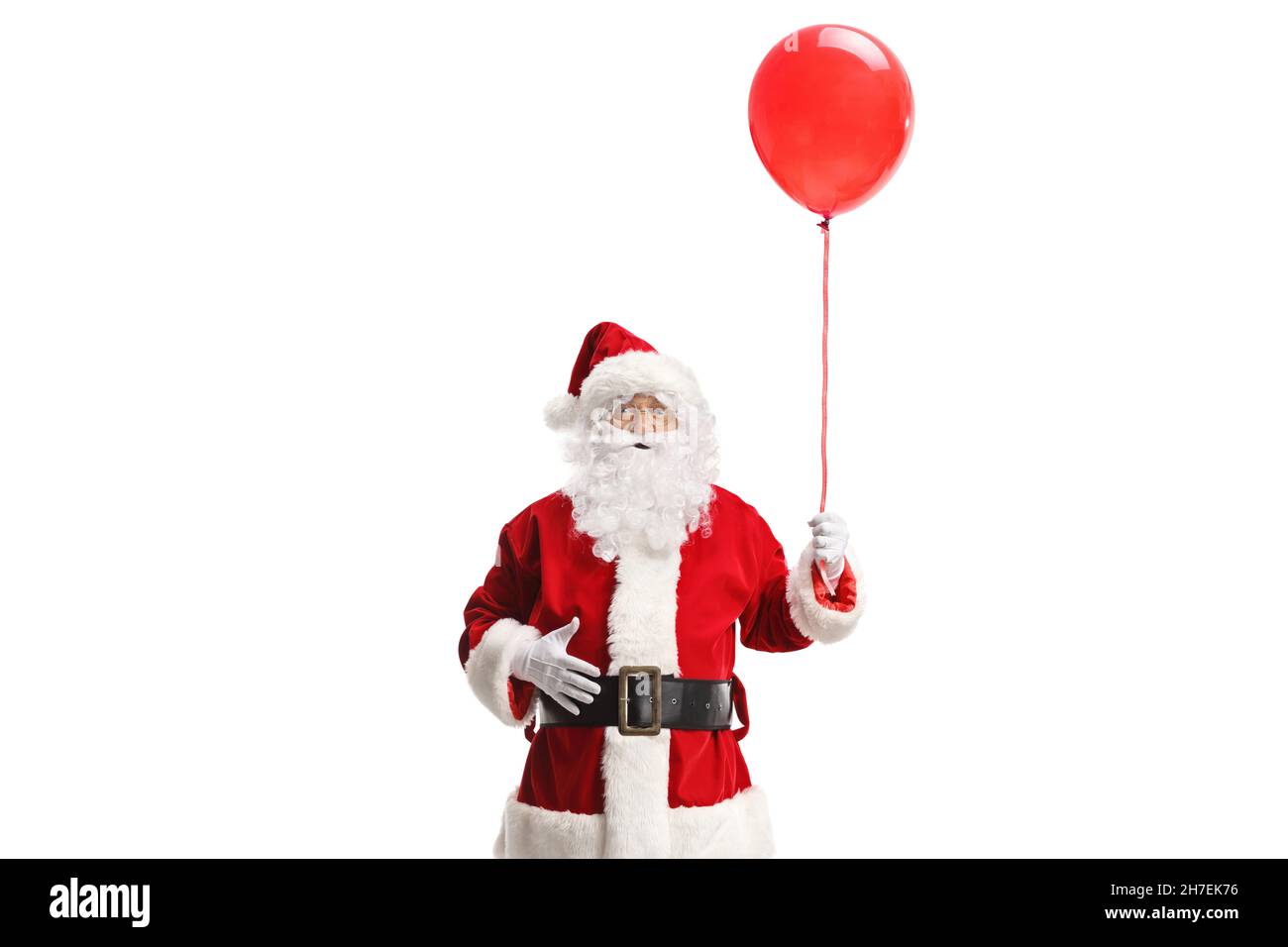 Santa claus holding a red balloon isolated on white background Stock Photo