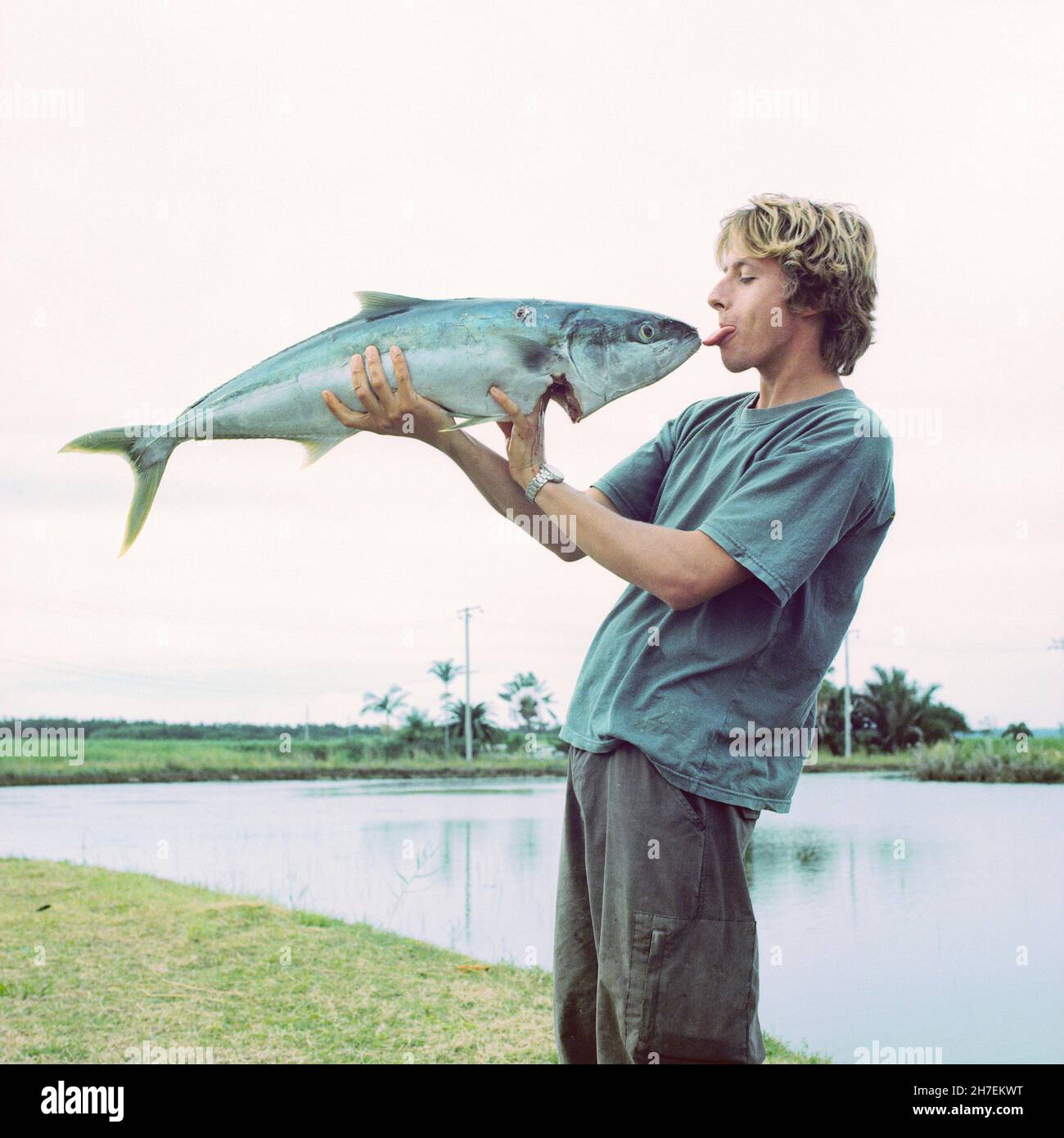 Young man with a large king fish, Queensland Australia. Stock Photo