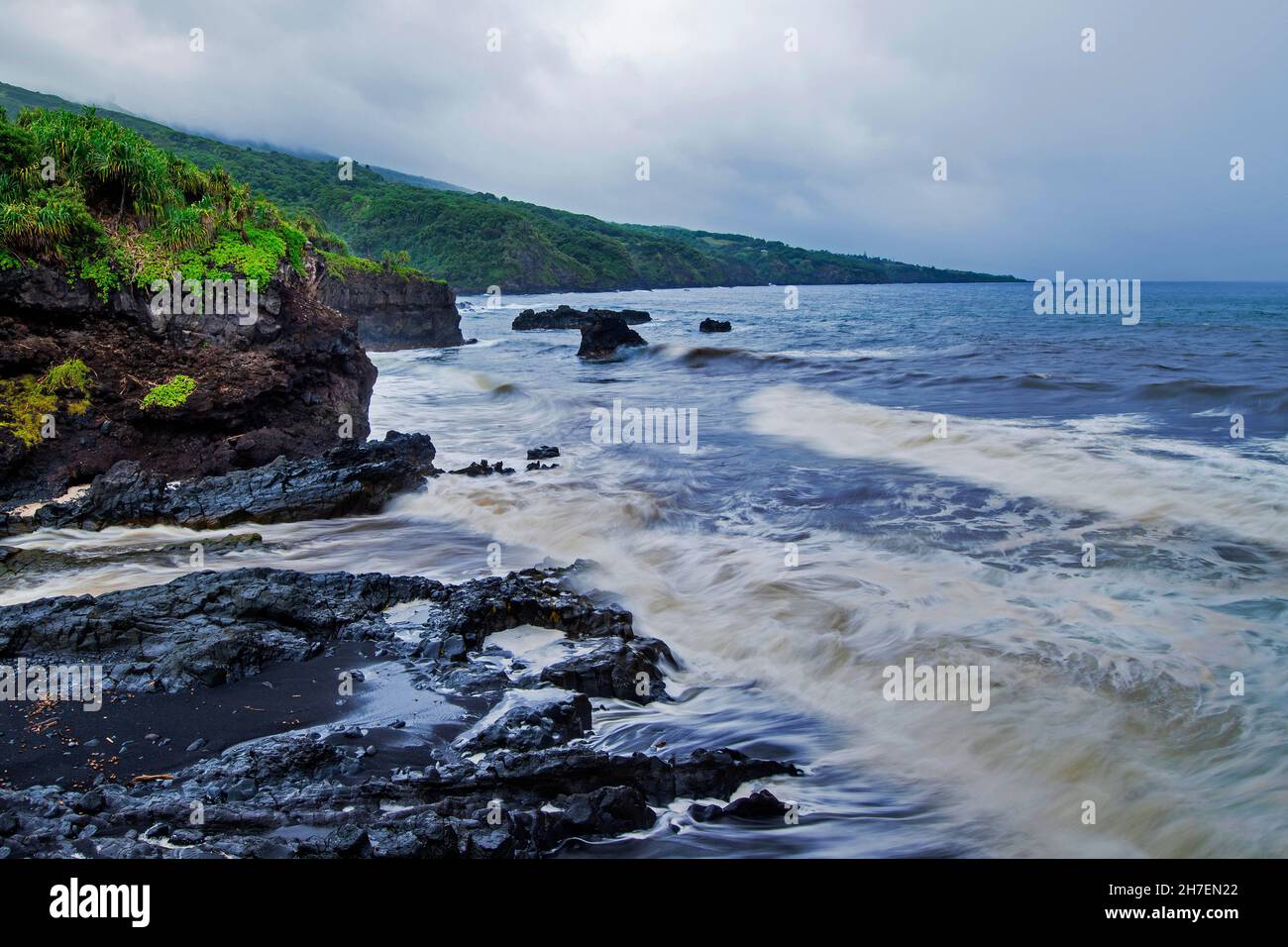 Palikea Stream running through volcanic rock into the ocean, Haleakala National Park, Maui, Hawaii Stock Photo