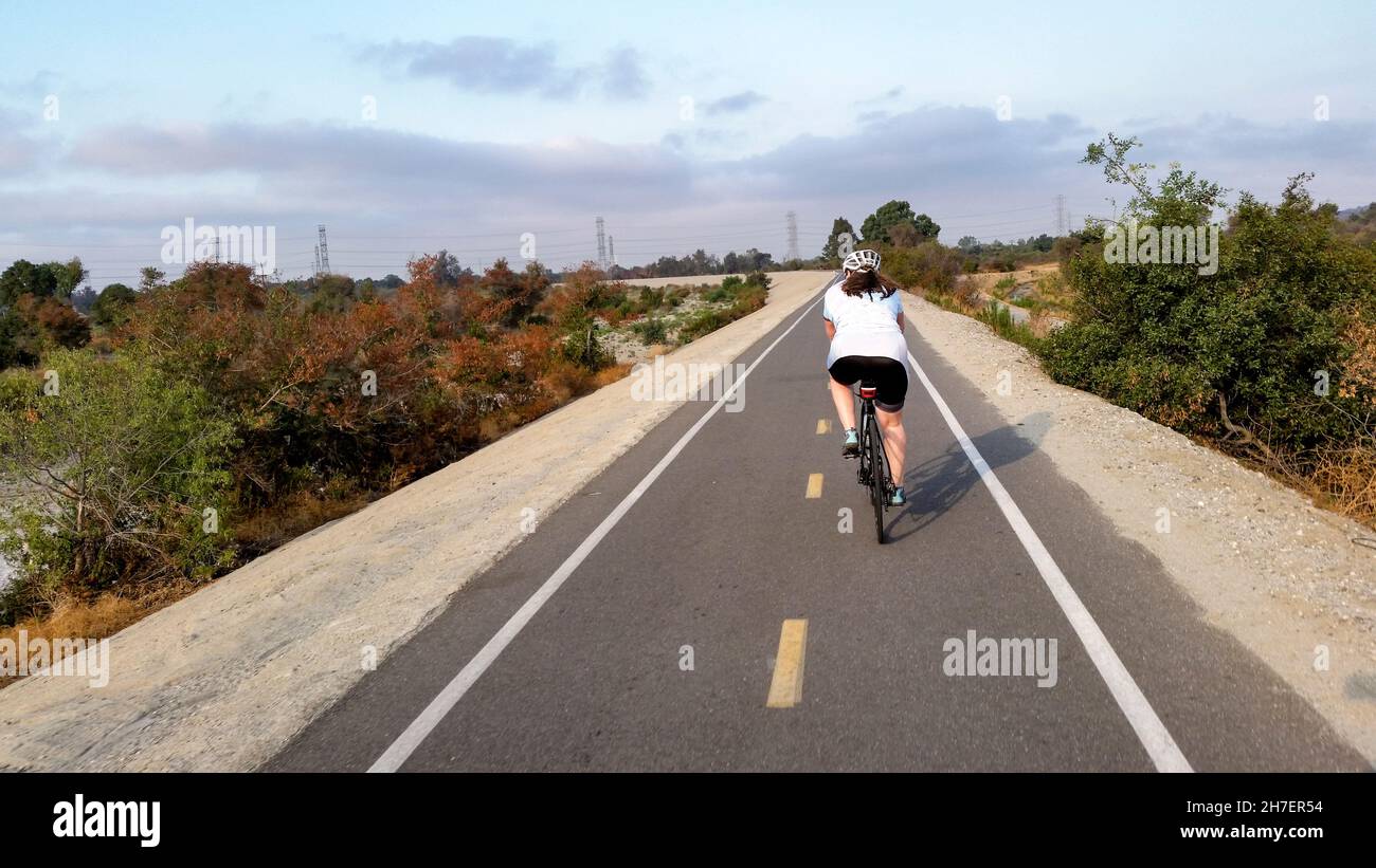 Cycling down the San Gabriel River bike path in the middle of summer Stock Photo