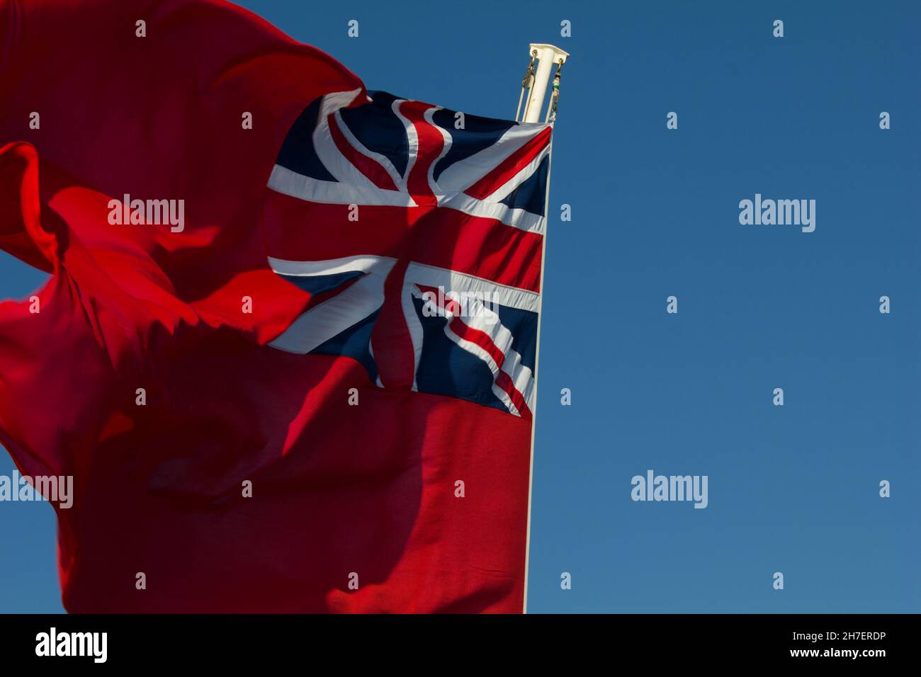 Red Ensign flag also known as the Red Duster.  Flown by British merchantman or civil ships. Stock Photo
