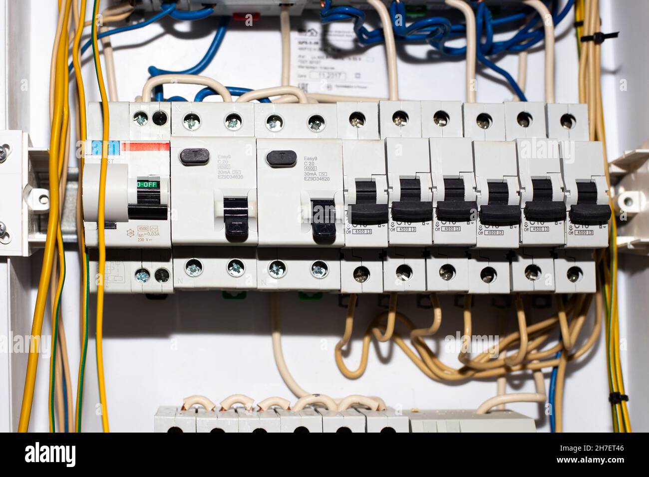 Electrical panel with toggle switches and wires. Installation of lead