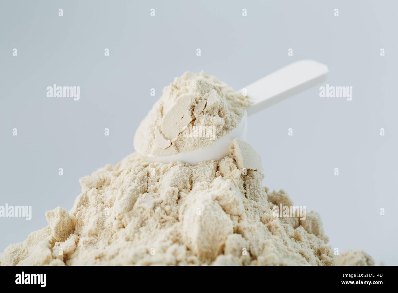 https://c8.alamy.com/comp/2H7ET4D/whey-protein-isolate-with-a-measuring-spoon-on-a-white-background-sports-nutrition-of-athletes-2H7ET4D.jpg