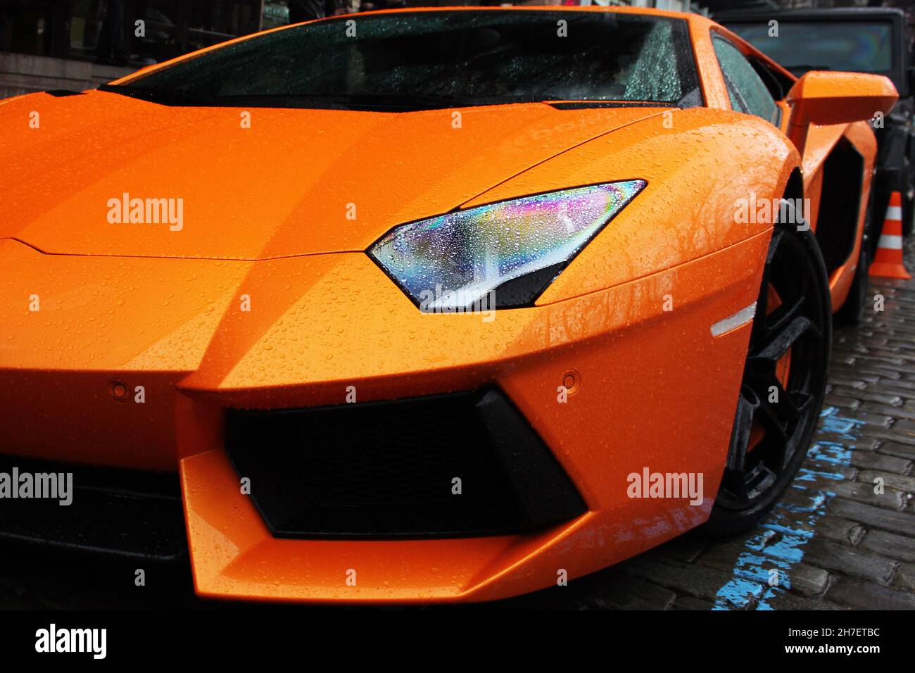 Part of an orange car close up. Car in raindrops Stock Photo