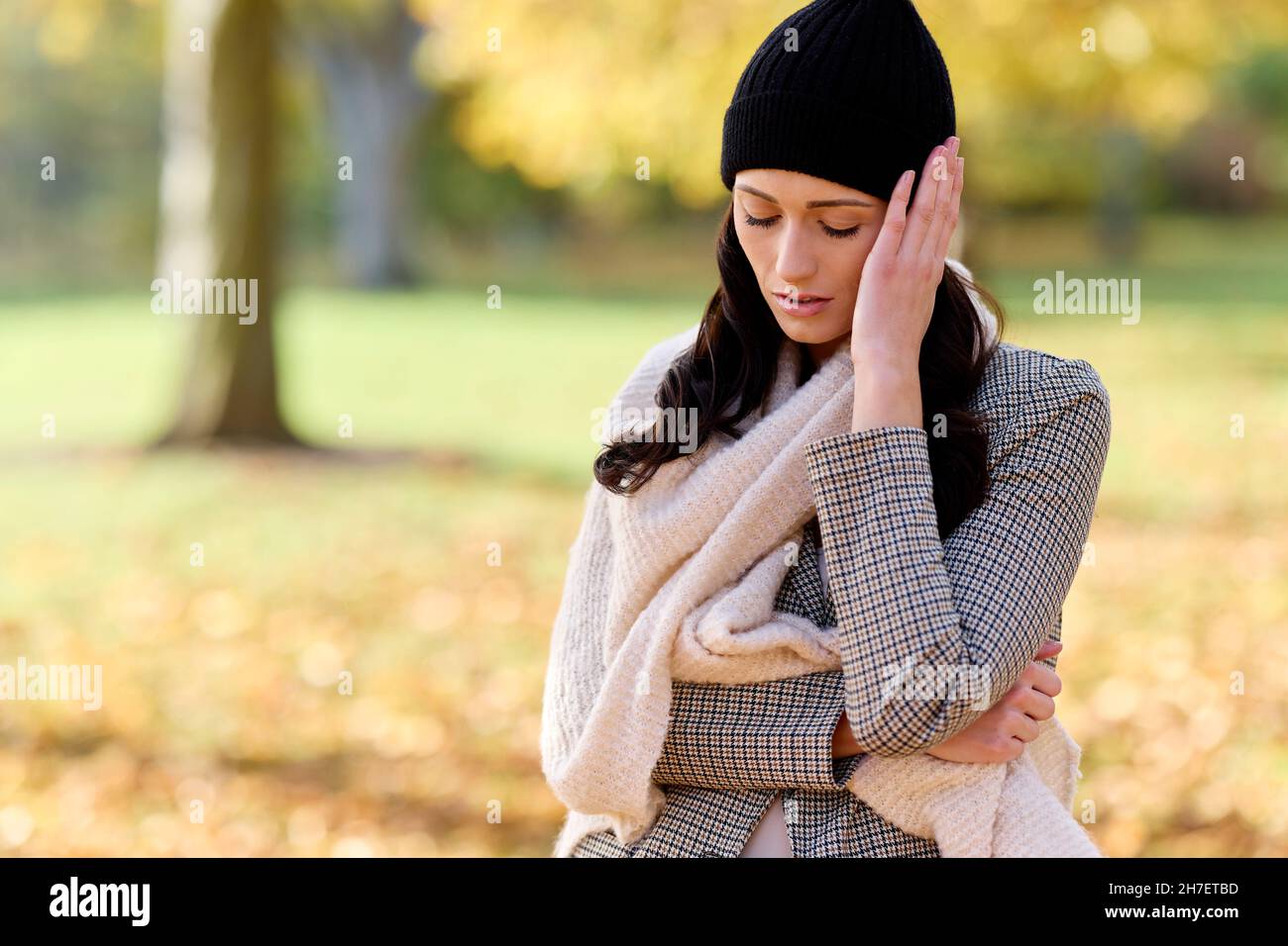 Woman looking concerned outdoors Stock Photo